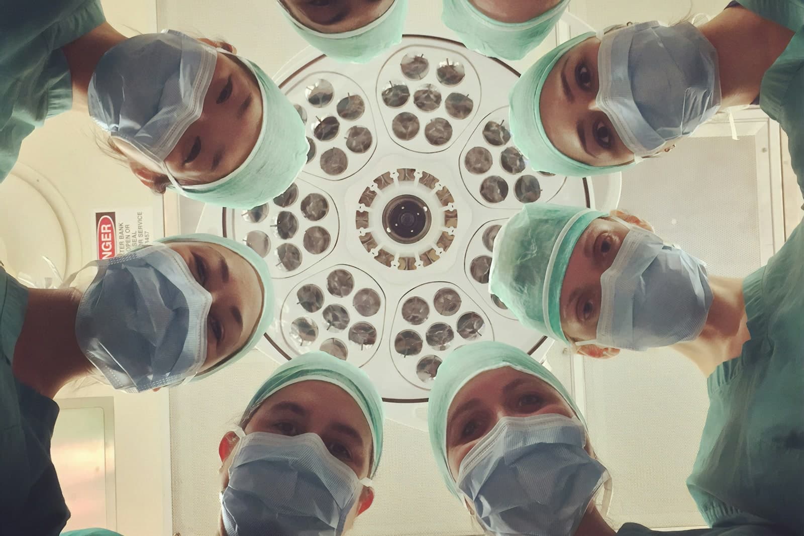 Surgical team under operating lights, representing clinical safety context.